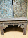 Carved wooden console with intricate patterns  