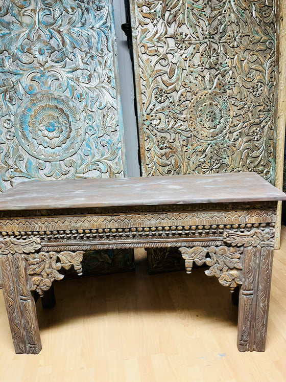 Carved wooden console with intricate patterns  