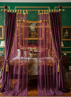 Purple curtains with gold accents as bed canopy curtains