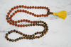 Discover Rudraksha Tiger Eye Beads Japa Mala, hand-knotted for strength, balance, and spiritual practice. Ideal for yoga, meditation, and healing.