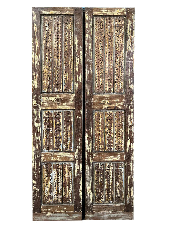 Pair of ornate wooden doors with intricate carvings on a white background