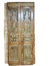 Vintage wooden door with intricate carvings among other decorative elements.