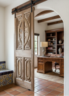 Wooden sliding door with decorative carvings in a room wooden furniture.