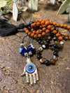 Protecting against negativity: evil eye pendant necklace, Rudraksha Mala